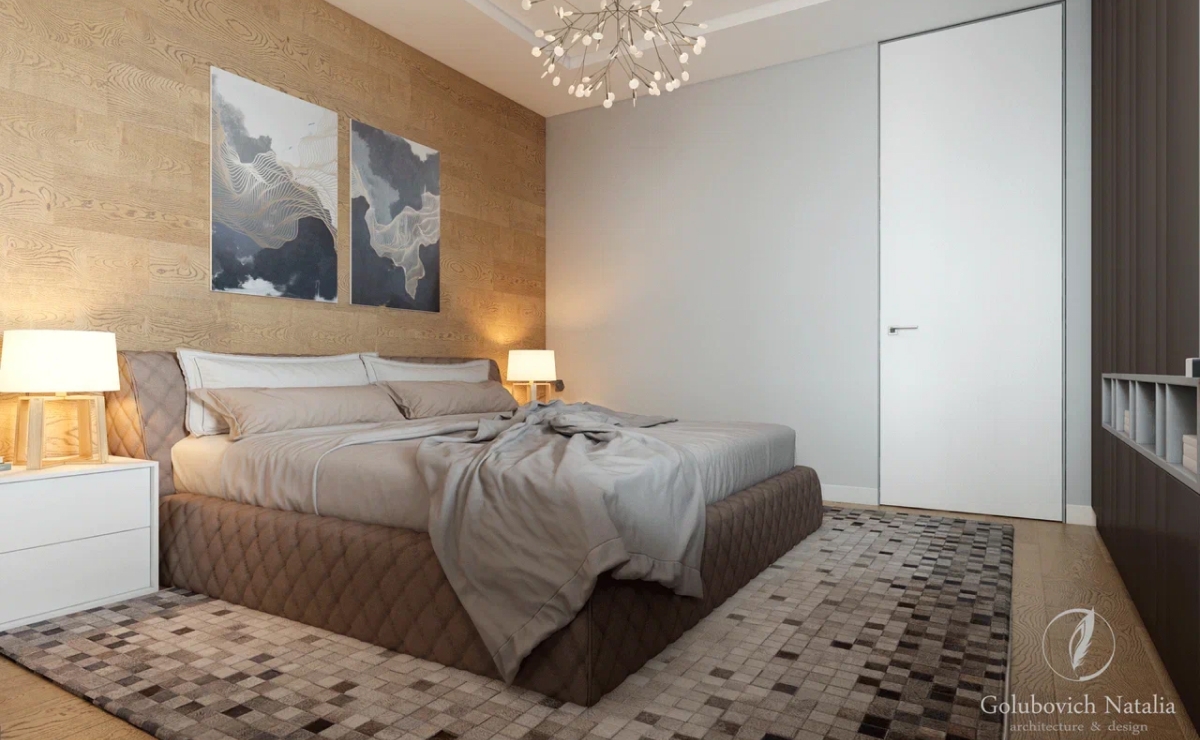 Дизайн-проект интерьера был разработан в стиле минимализм, так как данный стиль можно охарактеризовать как моделирование пространства и света с использованием только необходимых предметов. В стиле минимализм все поверхности просты и лаконичны, без какого-либо декора, украшений и отделки. <br>
В проекте использовали нейтральную цветовую палитру – теплые серые стены, деревянный пол из дуба, графитовый серый и белый лак. <br><br>

Чтобы создавалось ощущение простора, помещение по возможности освободили от внутренних перегородок, и композиционным центром интерьера стала гостиная. <br><br>

Дизайнер стремился уйти от деталей, чтобы пространство было единым. Также были заменены обычные двери на двери-невидимки. В случаях, когда полотно и отделка стены в одном тоне, как в нашем дизайн проекте, можно использовать алюминиевый профиль на торец полотна и полотно на тон светлее стены, нежели основная стена. <br>
Мебельная композиция (встроенный шкаф по эскизам дизайнера) перетекает из одного пространства в другое, рисунок фасадов привносят свой ритм в композицию. <br><br>

Изюминкой интерьера стала мебель фабрики Cattelan Italia (стол, стулья, диван) и подвесной светильник Moooi. <br><br>

В отделке спальни нет ничего лишнего, в оформлении преобладает оттенок серого, но она не кажется скучной и безликой. Облицовка одной из стен в спальне выполнена деревянными панелями с чёткими горизонтальными линиями. В ванной комнате присутствует та же «прямолинейность» – вся сантехника имеет правильные геометрические формы. 