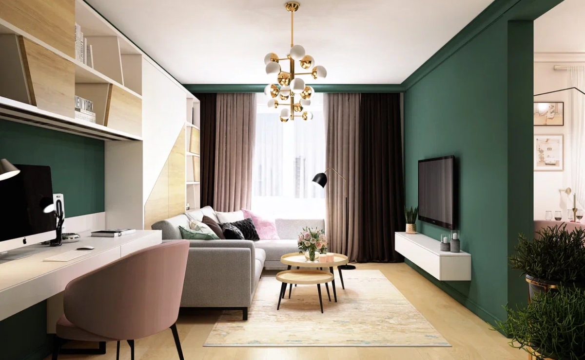 Применяя правило «меньше стен – больше пространства», в авторском дизайн-проекте однокомнатной квартиры объединили ванную и санузел. За счет этого получилось больше полезного архитектурного пространства, которое использовали под душевую кабину, умывальник, бытовую технику.<br>
В основной комнате предусмотрено несколько важных функциональных зон: <br>
– спальня, которая воплотилась с помощью складной кровати Murphy; <br>
– зона отдыха – диван в собранном положении, телевизор с нижней консолью для хранения мелочей; <br>
– рабочая зона. <br><br>

Отказавшись от стерильного белого цвета, сделали акцент на светлые тона. Входная дверь с шелковисто-матовой поверхностью буквально отражает каждый луч, что позволяет визуально расширить пространство. Грамотно используя стенки коридора, превратили их в систему хранения. <br>
Светлые оттенки продолжаются и в оформлении фасадов кухонной мебели, а рабочий фартук декорирован каменными плитами из коричневого мрамора. Для контраста варочная поверхность и мойка представлены в черном цвете. <br><br>

Ярким акцентом между коридором и основной комнатой стал насыщенный темно-зеленый цвет. С коридора в жилое пространство он переходит из дверной деревянной рамы и продолжается визуальным панно на стене. В таком же цвете оформлена смежная часть и с кухней-столовой. <br>
Кроме объединяющего насыщенного темно-зеленого цвета, ключевым аспектом стала мебель – легкий розовый оттенок кресел-стульев, характерных для скандинавского стиля, используются для кабинетного пространства и для столовой. <br><br>

Реализация этого проекта под ключ еще раз доказала: немного больше 40-ка квадратных метров – вполне допустимая площадь, чтобы сделать ее комфортной и функциональной, если отказаться от привычного размещения мебели и соединить несколько фактур в отделке. Применяя приемы из классического, скандинавского, кантри и даже модернового интерьера, собрали цвета, мебель и атрибуты, которые добавили уюта, но не забрали простор.
