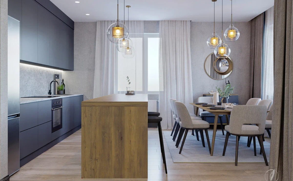 В проекте соединены классические и современные мотивы, связывающие интерьер воедино с помощью уравновешенной палитры натуральных оттенков белого и серого. Светлые цвета поднимают настроение и дают ощущение чистоты. <br>
Несмотря на классическое цветовое решение, интерьер современный. Таковым его делает игра фактур в отделке, лестница со стеклянными перилами, геометрия линий, а также использование металла в меблировке. Патинированная бронза, латунь, темный металл или сияние хромированной стали – металлические акценты-вставки используют во всех типах мебели. <br><br>

На первом этапе основным оттенком стен и потолков стал серый, на который хорошо ложится свет из окон. Чтобы еще лучше осветить пространство первого этажа, в проекте интерьера таунхауса активно используются возможности искусственного и естественного освещения. 
Подбор предметов в интерьере функционален и эстетичен – здесь массивное удобное кресло, стильный удобный пуф, элегантные круглые зеркала, футуристичные бра. <br><br>

Гостиная в доме объединена с кухней и столовой; там же сконструирована оригинальная лестница со стеклянными перилами на второй этаж. <br>
 В центре большой функциональной кухни расположен остров с зоной для кофепауз или посиделок вдвоем, а также закрытые полки для хранения посуды и утвари. С одной стороны – большой обеденный стол, с другой – территория для приготовления пищи. Аккуратность и чистоту интерьера подчеркивают гладкие однотонные строгие линии. Сочетание дерева и серого и графичное цветовое решение с акцентной деревянной столешницей на насыщенно-сером фоне всегда смотрится беспроигрышно. Не обошлось и без эффектных контрастов: минималистские шкафы соседствуют с люстрами, напоминающими арт-объект из стекла и металла. <br><br>

Среди светлых комнат оригинальным акцентом выделяется гардеробная с рабочей зоной. Нам удалось создать такую игру планировки, разместив между шкафами для одежды рабочий письменный стол. Неплохая идея – в такой обстановке от работы точно ничто не отвлекает.
<br><br>
В подвале таунхауса разместили комнату отдыха-кинозал, небольшое помещение для занятия спортом, большую гардеробную, а также хозяйственное помещение. <br>
В кинозале за диваном разместили барную стойку и стулья для тех, кто пожелает сменить ощущение семейных посиделок на веселье с друзьями. <br><br>

Реализованный проект демонстрирует, каким именно должен быть идеальный дом – просторный, комфортный, стильный и функциональный. 
